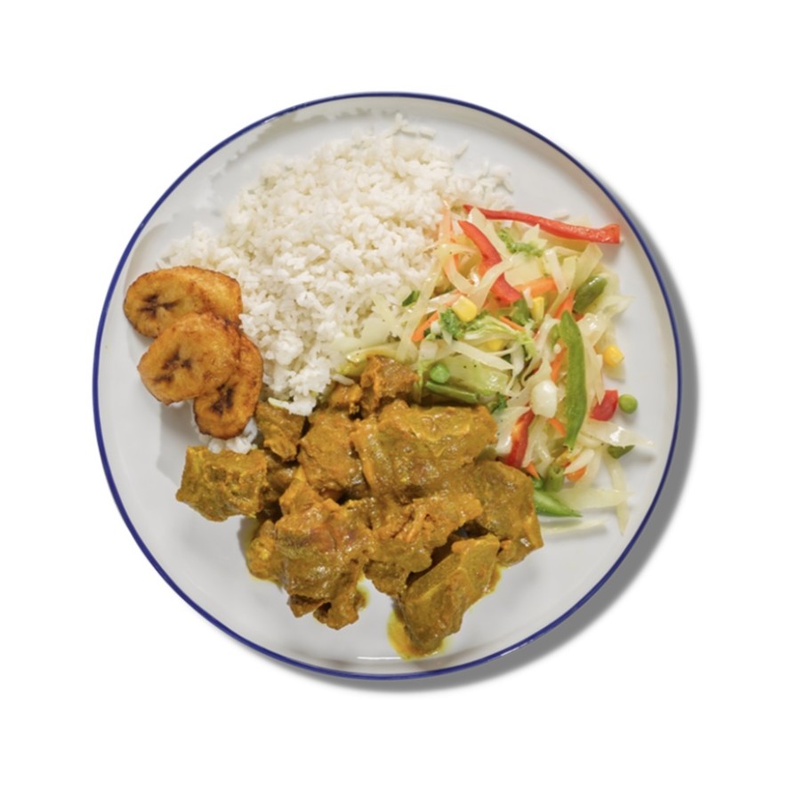 Curry Goat plate with rice, fried plantain, and vegetable slaw